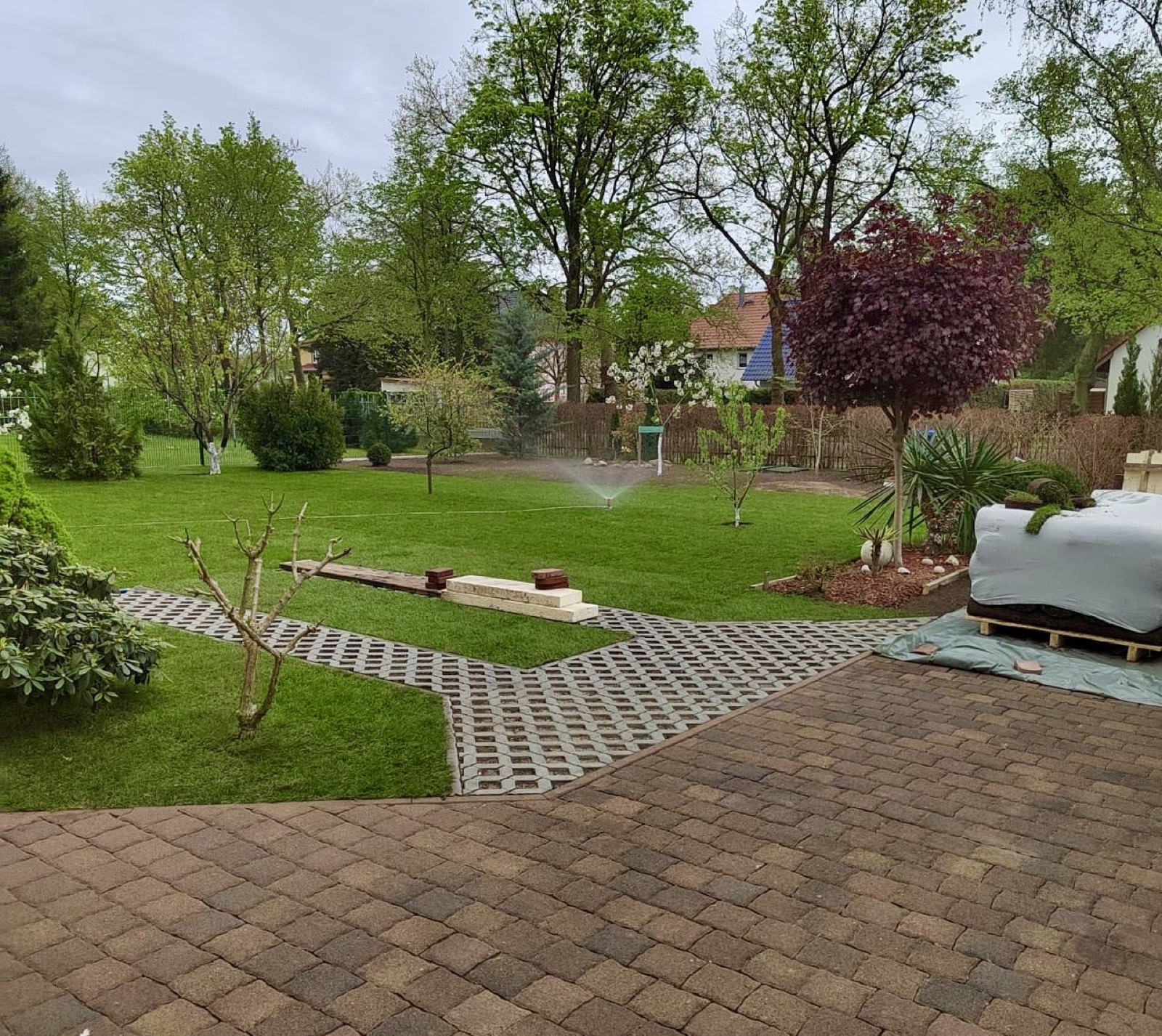 Angelegte Gartenanlage in Wildau mit Rasenfläche und Pflasterterrasse